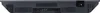 The back view of a black and gray electronic device, likely a television or similar media device, showing various ports and vents. Produktbild-Vorschau