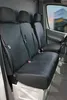 Interior view of a van showing black seat covers on the front seats. Produktbild-Vorschau