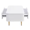 A white coffee table with gold legs and open drawers. Produktbild-Vorschau