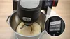 A close-up of a kitchen mixer with dough in the bowl, and a magnified view of the digital display showing program options. Produktbild-Vorschau
