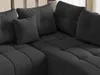 A close-up view of a dark gray sectional sofa with tufted cushions and throw pillows. Náhled obrázku produktu