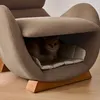 A cat is resting inside a unique, modern armchair designed with a built-in cat bed. Náhľad obrázku produktu