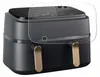 A dark gray Philips Airfryer with gold handles is shown, with a clear protective film overlaying the top display panel. Produktbild-Vorschau