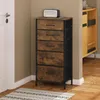 A tall, narrow dresser with five drawers is placed in a corner next to a white door and a wooden cabinet. Produktbild-Vorschau