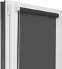 A close-up view of a dark gray roller blind installed on a white window frame.