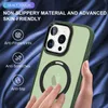A hand is holding a green iPhone case with a magnetic ring for MagSafe. The background is a dark, silky fabric. Produktbild-Vorschau