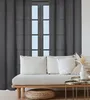 A living room scene with a sofa and curtains. Produktbild-Vorschau