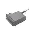 A close-up shot of a grey power adapter with European-style prongs. Produktbild-Vorschau