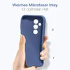 A hand holding a blue phone case with a white background. Produktbild-Vorschau