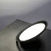 A high-bay LED light fixture is shown on a dark surface with a gray background. Podgląd zdjęcia produktu