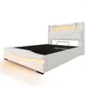 A white upholstered bed frame with integrated LED lighting. Voir les images du produit
