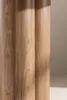 A close-up view of the textured wood grain of a cylindrical object, with soft lighting and shadows. Produktbild-Vorschau