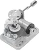A close-up, studio shot of a music box mechanism. Voir les images du produit