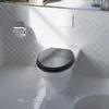 A toilet in a bathroom with tiled walls and floor. Náhled obrázku produktu