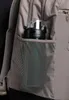 A close-up view of a water bottle in the side pocket of a backpack. Anteprima dell’immagine prodotto