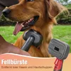 A person is grooming a Golden Retriever dog with a grooming brush. The dog is sitting outdoors in grass. Produktbild-Vorschau