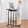 A woman is using a standing desk in an office or home environment. Anteprima dell’immagine prodotto