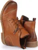 A pair of brown leather boots shown from a diagonal angle against a white background. Produktbild-Vorschau