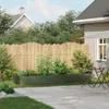 A backyard scene with a raised garden bed filled with plants, a wooden fence, and patio furniture. Náhľad obrázku produktu