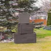 Three stacked storage boxes in a garden setting. Podgląd zdjęcia produktu