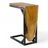 A close-up studio shot of a C-frame side table made of teak wood and metal. Voir les images du produit