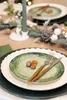 A festive table setting with plates, cutlery, and holiday decorations. Produktbild-Vorschau
