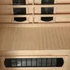 Interior view of a wooden sauna cabin, showing ventilation grilles and wooden paneling. Produktbild-Vorschau