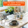 A dining table set with place settings, glasses, and a decorative lantern. Produktbild-Vorschau