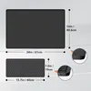 Two black silicone mats are shown with dimensions indicated by lines and text. One is a larger rectangular mat, and the other is a smaller, textured mat. Close-up insets show the thickness of the mats. Produktbild-Vorschau
