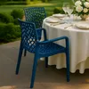 An outdoor dining setting with blue chairs and a table set for a meal. Produktbild-Vorschau