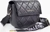 A black quilted Valentino handbag with a wide branded strap is shown against a white background. Anteprima dell’immagine prodotto