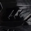 A close-up, abstract view of a black carbon fiber textured surface with angular, glossy black accents. Produktbild-Vorschau