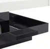 A close-up view of a modern table with drawers, showing the glossy white tabletop and black drawer compartments. Produktbild-Vorschau