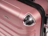 A close-up view of the corner of a rose gold suitcase. Náhled obrázku produktu