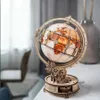 A wooden globe model with illuminated continents sits on a white surface, with a blurred background of a room. Anteprima dell’immagine prodotto