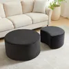 Two ottomans are placed on a rug in front of a couch. Produktbild-Vorschau