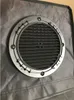 A close-up view of a round ventilation grille attached to a gray fabric surface. Produktbild-Vorschau