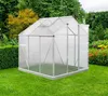 A greenhouse in a garden setting with flowers and trees. Produktbild-Vorschau