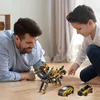 A father and son are playing with transformer toys on the floor. Náhled obrázku produktu