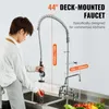A person is using a commercial kitchen faucet to wash a tomato in a sink. Podgląd zdjęcia produktu