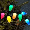 Colorful Christmas lights are strung on a dark, wet evergreen tree, suggesting outdoor use in rainy weather. Produktbild-Vorschau