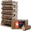 A pallet of compressed wood briquettes for fuel, with a smaller package of briquettes and one loose briquette in the foreground. Produktbild-Vorschau