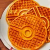 A close-up shot of several Pokemon-themed waffles on a white plate. Podgląd zdjęcia produktu