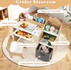 A children's desk and chair set with storage, featuring toys and books. Produktbild-Vorschau