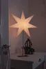 A lit paper star lamp sits on a white table next to a potted plant. A rope is hanging from a hook on the left side of the image. Produktbild-Vorschau