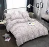 A bedroom scene with a bed made up with floral bedding. Náhled obrázku produktu