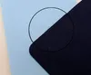 A close-up view of two different fabric textures, one light blue and one navy blue, with a circular magnifying effect highlighting the weave of both. Produktbild-Vorschau