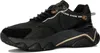 A black Guess sneaker with gold accents, shown from a side angle on a white background. Produktbild-Vorschau