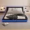 A modern bedroom with a black upholstered bed frame featuring blue LED lighting. Produktbild-Vorschau