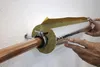 A person is installing pipe insulation around a copper pipe attached to a wall. Produktbild-Vorschau
